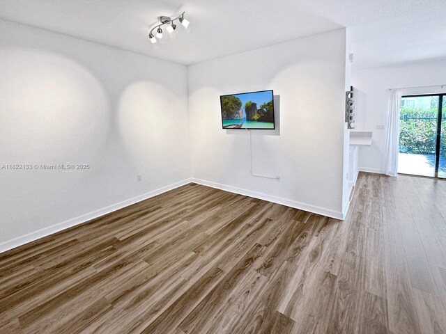 6011 W Paso Fino Pl, Davie, FL 33314 - unfurnished living room featuring wood finished floors
