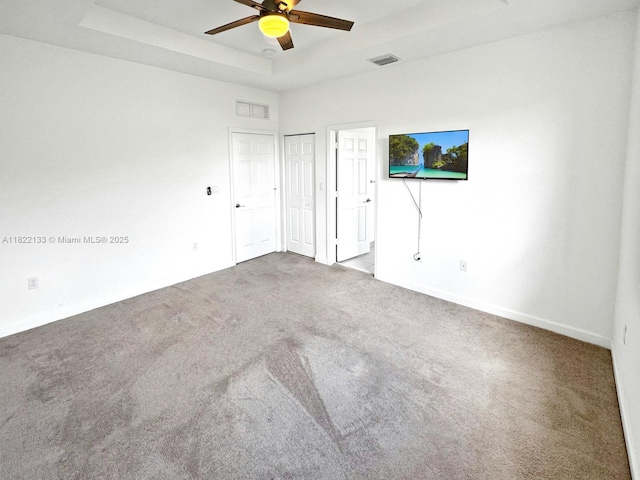 6011 W Paso Fino Pl, Davie, FL 33314 - unfurnished bedroom featuring carpet, a tray ceiling, and a ceiling fan