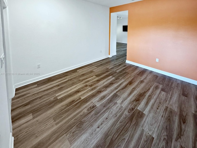 6011 W Paso Fino Pl, Davie, FL 33314 - empty room featuring dark wood-style flooring and baseboards