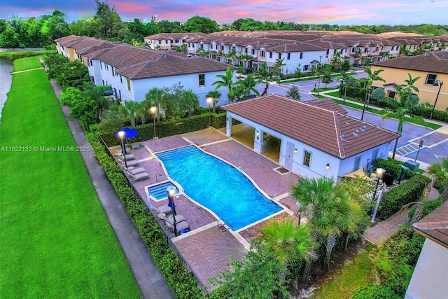 6011 W Paso Fino Pl, Davie, FL 33314 - view of pool with a residential view, a pool with connected hot tub, and a patio