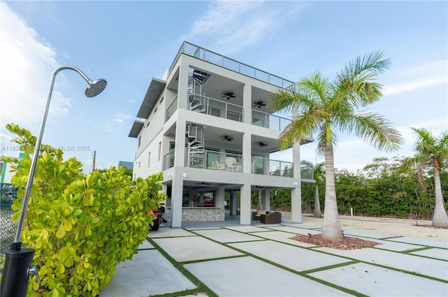 475 Bahia Honda Rd, Key Largo, FL 33037 - back of house with a ceiling fan, a balcony, a patio, stucco siding, and outdoor lounge area