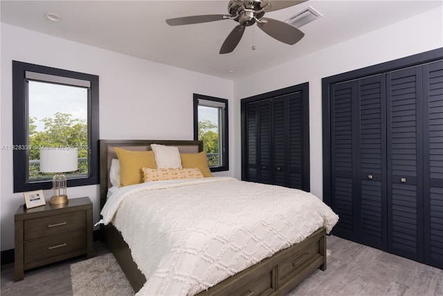 475 Bahia Honda Rd, Key Largo, FL 33037 - bedroom featuring light wood-style floors, multiple closets, and a ceiling fan