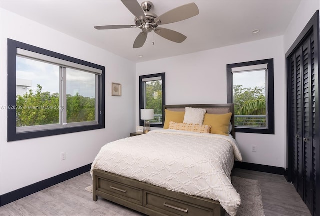 475 Bahia Honda Rd, Key Largo, FL 33037 - bedroom with light wood finished floors, multiple windows, and a ceiling fan