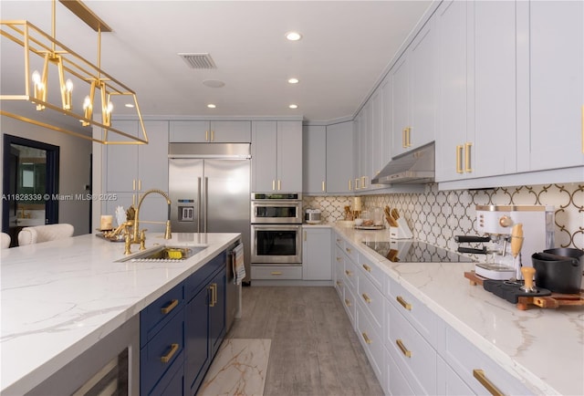 475 Bahia Honda Rd, Key Largo, FL 33037 - kitchen with under cabinet range hood, stainless steel appliances, recessed lighting, tasteful backsplash, and light stone counters