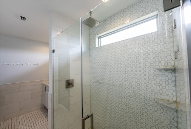 475 Bahia Honda Rd, Key Largo, FL 33037 - bathroom featuring a shower stall, tile walls, vanity, and wainscoting