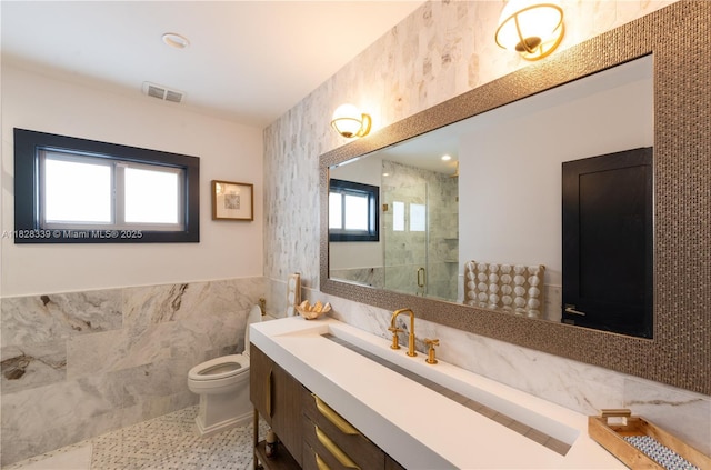 475 Bahia Honda Rd, Key Largo, FL 33037 - bathroom with tile walls, vanity, a stall shower, a wainscoted wall, and tile patterned flooring