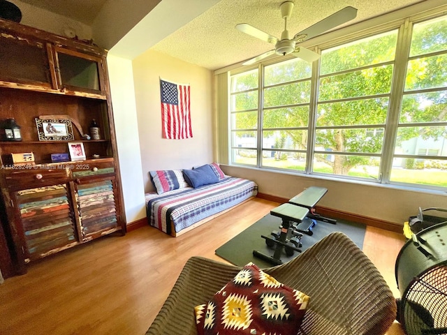 2860 SW 22nd Ave Unit 4100, Delray Beach, FL 33445 - bedroom with multiple windows, wood finished floors, and a textured ceiling