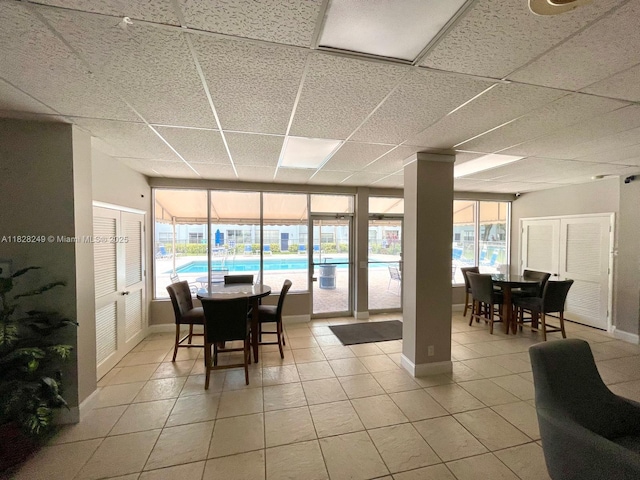 2860 SW 22nd Ave Unit 4100, Delray Beach, FL 33445 - dining space featuring light tile patterned flooring, a paneled ceiling, and healthy amount of natural light