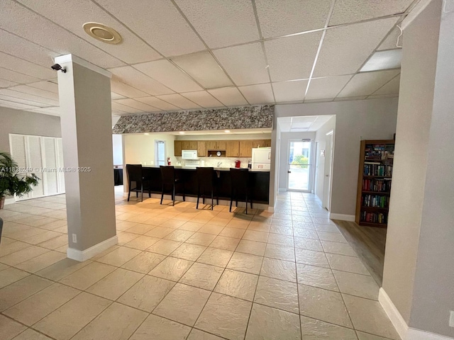 2860 SW 22nd Ave Unit 4100, Delray Beach, FL 33445 - bar area with a paneled ceiling, white microwave, fridge, and light tile patterned floors