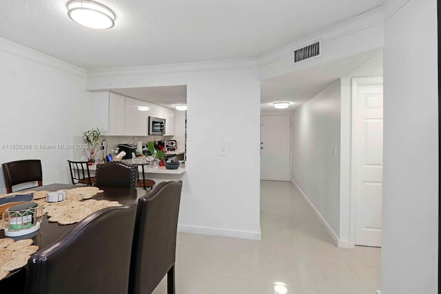 9917 W Okeechobee Rd Unit 3-303, Hialeah Gardens, FL 33016 - dining space featuring crown molding, light tile patterned floors, and a textured ceiling
