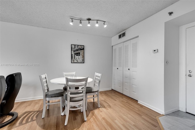 770 Claughton Island Dr Unit 1210, Miami, FL 33131 - dining area with light wood-type flooring and a textured ceiling