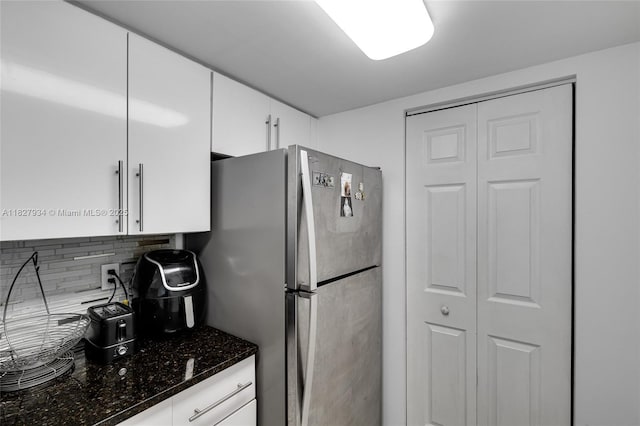 770 Claughton Island Dr Unit 1210, Miami, FL 33131 - kitchen featuring freestanding refrigerator, decorative backsplash, dark stone counters, and white cabinets