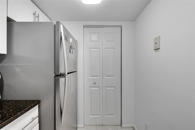 770 Claughton Island Dr Unit 1210, Miami, FL 33131 - kitchen featuring freestanding refrigerator, white cabinetry, and dark stone countertops