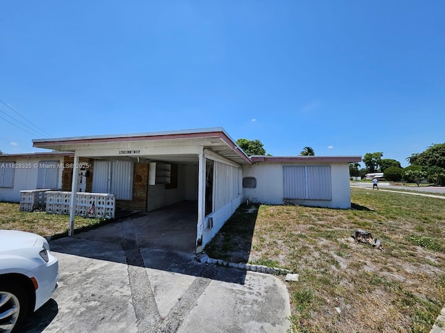 1501 NW 3rd Way, Pompano Beach, FL 33060 - view of side of property with concrete driveway and an attached carport
