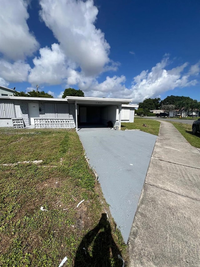 1501 NW 3rd Way, Pompano Beach, FL 33060 - view of front of house featuring driveway, a carport, and a front lawn