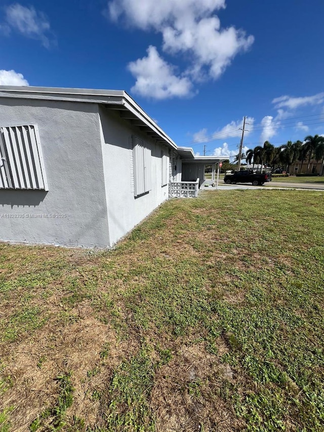 1501 NW 3rd Way, Pompano Beach, FL 33060 - view of side of property featuring stucco siding and a lawn