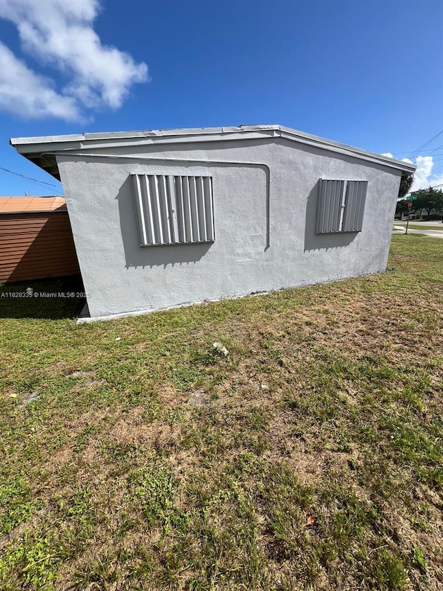 1501 NW 3rd Way, Pompano Beach, FL 33060 - view of side of property with a lawn and stucco siding