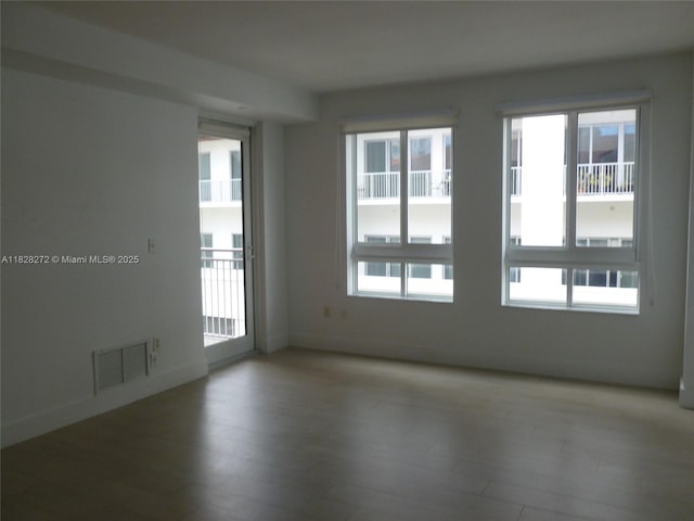 7350 SW 89th St Unit 808S, Miami, FL 33156 - spare room with plenty of natural light and wood finished floors