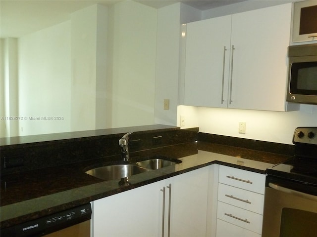 7350 SW 89th St Unit 808S, Miami, FL 33156 - kitchen featuring appliances with stainless steel finishes, white cabinets, and dark stone counters