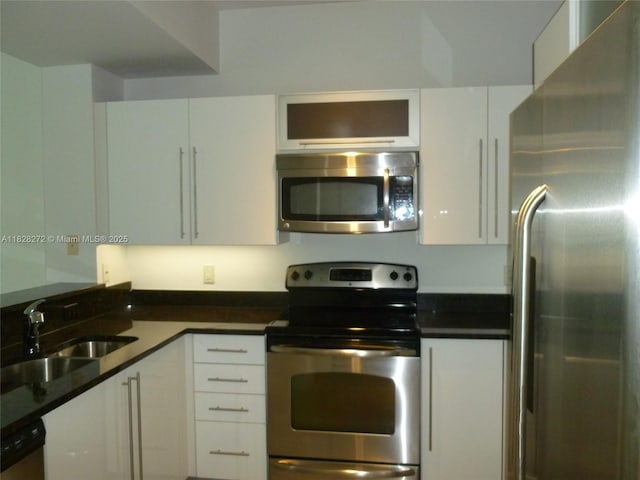 7350 SW 89th St Unit 808S, Miami, FL 33156 - kitchen with appliances with stainless steel finishes, white cabinetry, and dark countertops