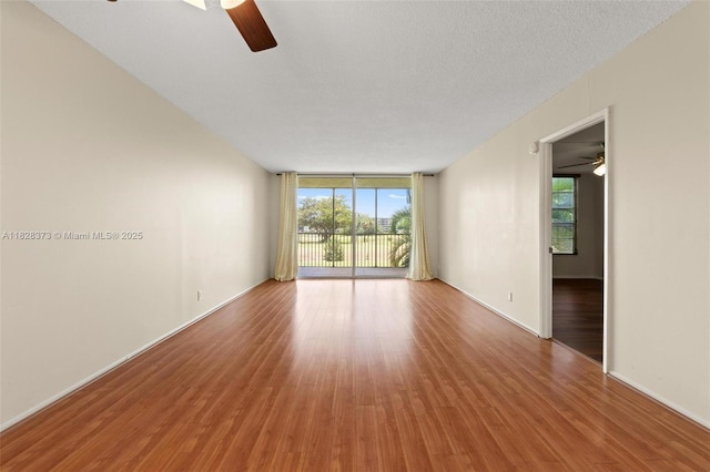 2851 S Palm Aire Dr Unit 205, Pompano Beach, FL 33069 - spare room with ceiling fan, wood finished floors, and floor to ceiling windows