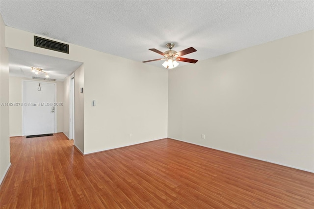 2851 S Palm Aire Dr Unit 205, Pompano Beach, FL 33069 - empty room featuring wood finished floors, a ceiling fan, and a textured ceiling
