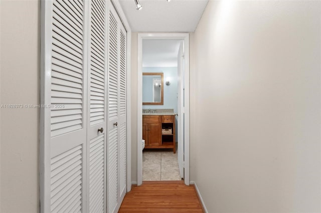 2851 S Palm Aire Dr Unit 205, Pompano Beach, FL 33069 - hall featuring light wood-type flooring and a sink