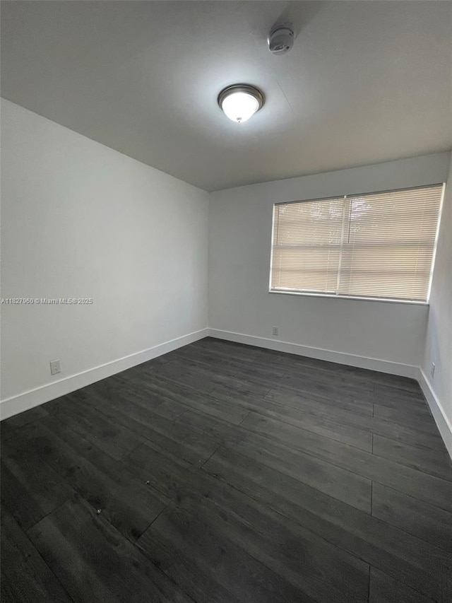 1842 Madison St, Hollywood, FL 33020 - empty room featuring a smoke detector and dark wood-type flooring