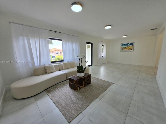 335 W 60th St, Hialeah, FL 33012 - living room with healthy amount of natural light and light tile patterned flooring