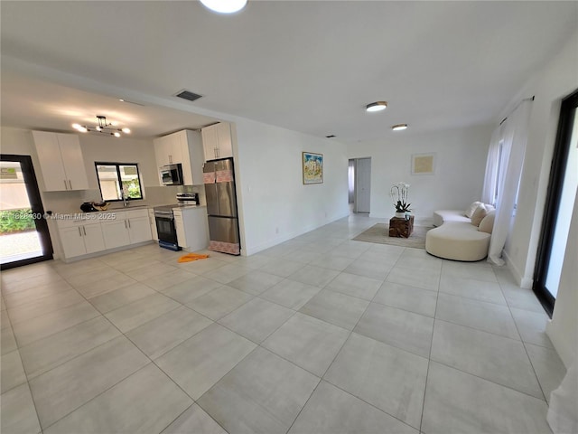 335 W 60th St, Hialeah, FL 33012 - living room with light tile patterned floors