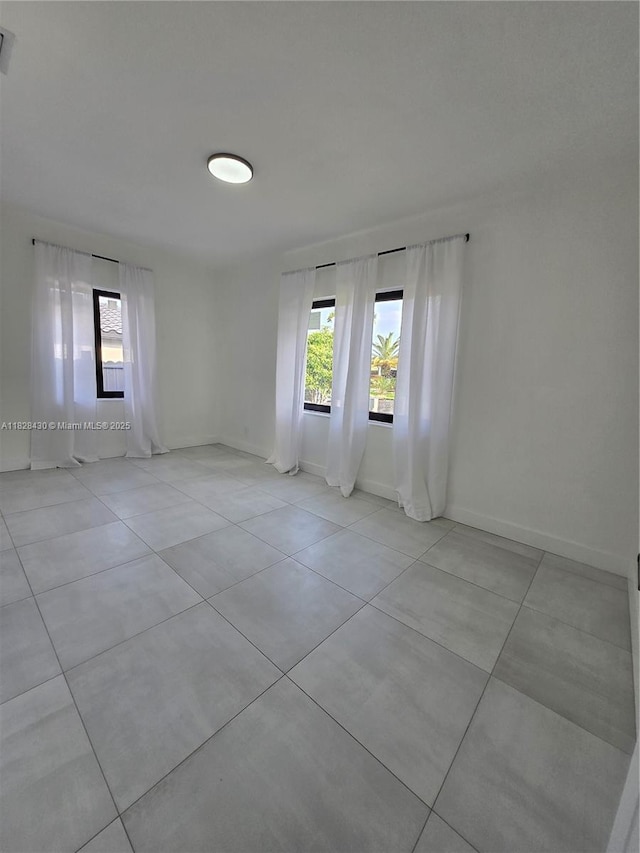 335 W 60th St, Hialeah, FL 33012 - unfurnished room featuring light tile patterned floors