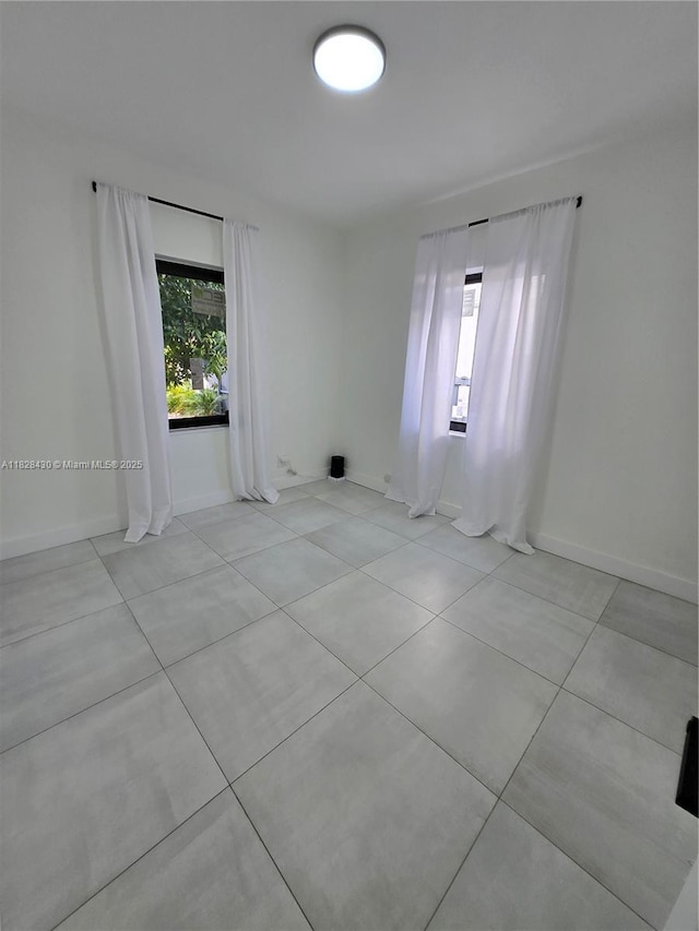 335 W 60th St, Hialeah, FL 33012 - tiled spare room featuring healthy amount of natural light