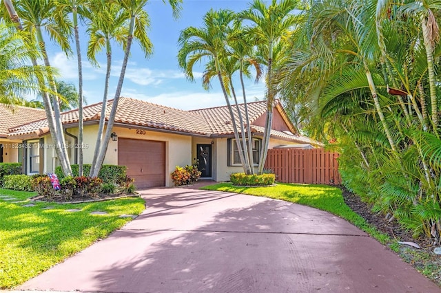 220 SW 113th Ter, Pembroke Pines, FL 33025 - view of front facade with an attached garage, stucco siding, a tiled roof, and concrete driveway