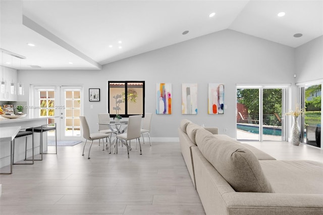 220 SW 113th Ter, Pembroke Pines, FL 33025 - living area with french doors, healthy amount of natural light, recessed lighting, high vaulted ceiling, and light wood finished floors