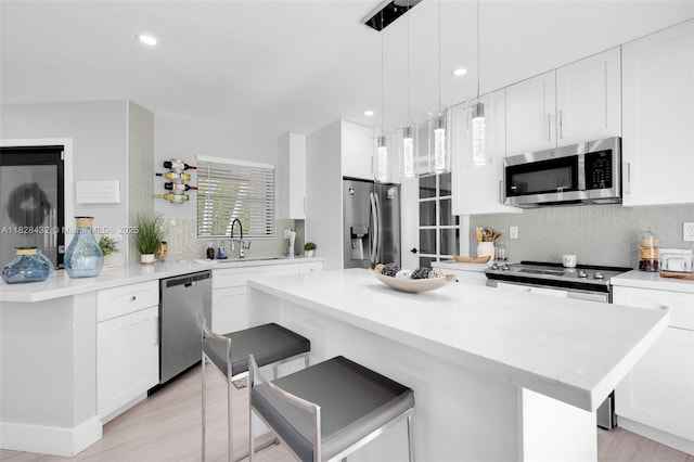 220 SW 113th Ter, Pembroke Pines, FL 33025 - kitchen with appliances with stainless steel finishes, a kitchen bar, tasteful backsplash, white cabinetry, and recessed lighting