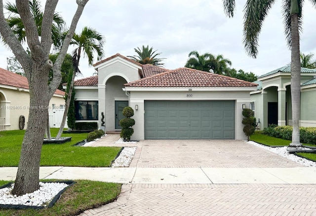 800 SW Tanglewood Cir, Weston, FL 33327 - mediterranean / spanish-style home with stucco siding, decorative driveway, a tile roof, and a garage