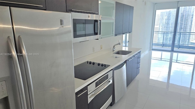 90 SW 3rd St Unit 4110, Miami, FL 33130 - kitchen with appliances with stainless steel finishes, modern cabinets, light countertops, and light tile patterned flooring