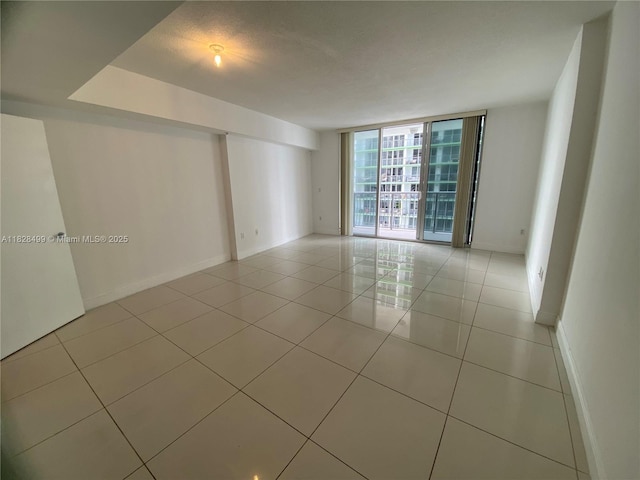 1750 N Bayshore Dr Unit 2707, Miami, FL 33132 - unfurnished room with light tile patterned flooring and expansive windows