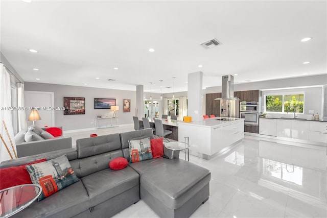 424 89th St, Surfside, FL 33154 - living room with recessed lighting and light marble finish flooring