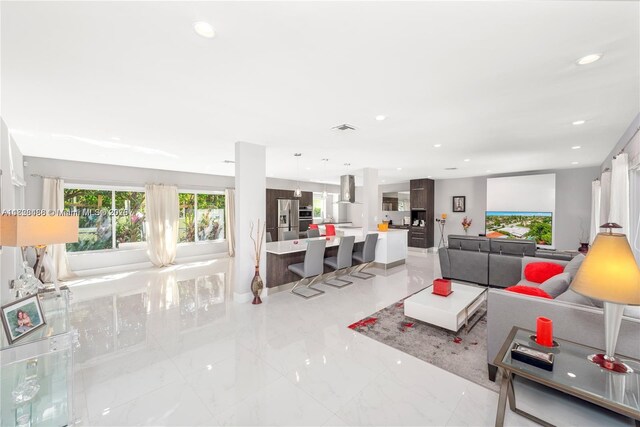 424 89th St, Surfside, FL 33154 - living room with recessed lighting and light marble finish flooring