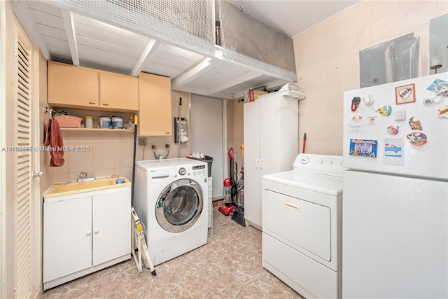 424 89th St, Surfside, FL 33154 - washroom with cabinet space, tile walls, and independent washer and dryer