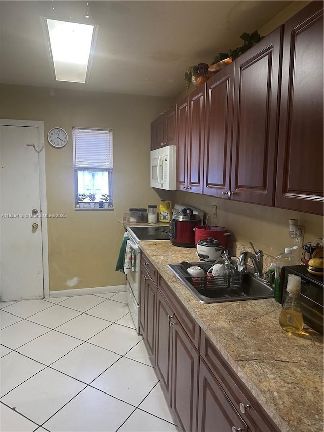 1900 W 54th St Unit 113, Hialeah, FL 33012 - kitchen featuring white microwave, light tile patterned floors, electric range, and light countertops