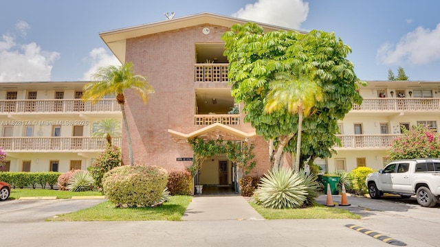16801 NE 13th Ave Unit 202, Miami, FL 33162 - view of property featuring uncovered parking