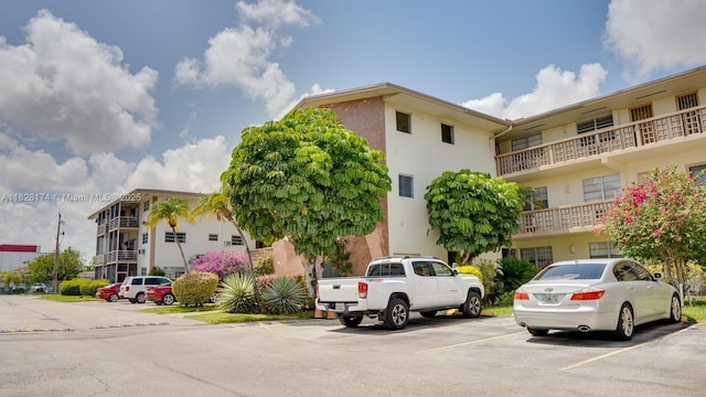 16801 NE 13th Ave Unit 202, Miami, FL 33162 - view of building exterior featuring uncovered parking