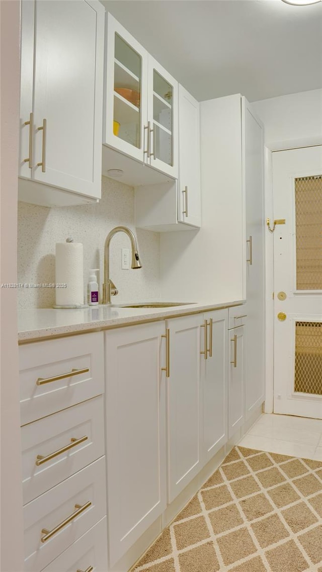 16801 NE 13th Ave Unit 202, Miami, FL 33162 - kitchen featuring white cabinetry, glass insert cabinets, and light tile patterned flooring