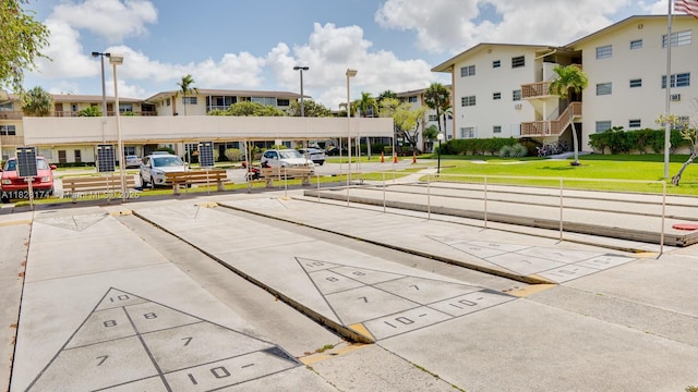 16801 NE 13th Ave Unit 202, Miami, FL 33162 - surrounding community with uncovered parking and a lawn