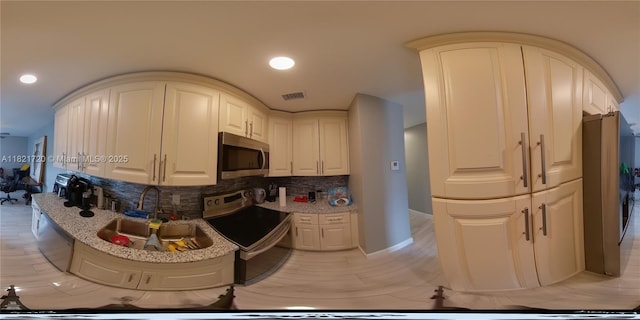 3705 NW 84th Ave Unit D5, Sunrise, FL 33351 - kitchen featuring appliances with stainless steel finishes, tasteful backsplash, light stone countertops, and recessed lighting