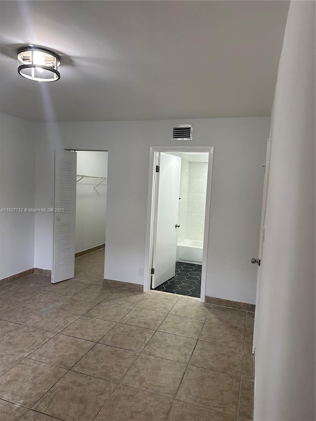 8100 Geneva Ct Unit 142, Doral, FL 33166 - unfurnished bedroom featuring tile patterned flooring, a closet, and ensuite bath