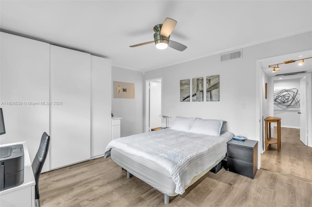 805 W Oakland Park Blvd Unit E14, Oakland Park, FL 33311 - bedroom with light wood finished floors, crown molding, and ceiling fan