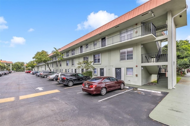 805 W Oakland Park Blvd Unit E14, Oakland Park, FL 33311 - view of apartment building / complex featuring uncovered parking and stairway